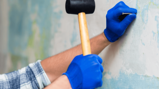 roofing hammer driving nail into shingles